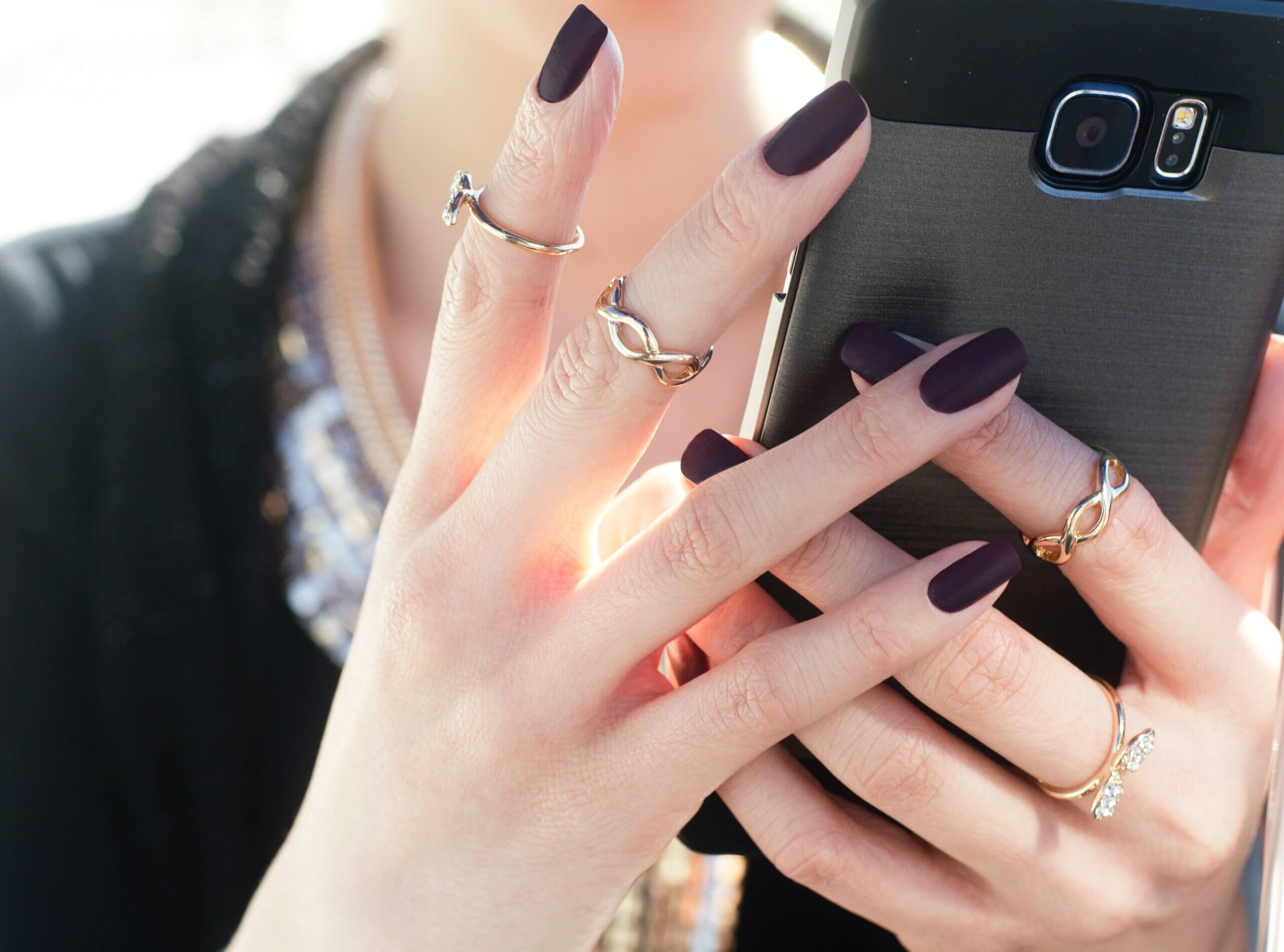 closeup of a woman's hands holding a cell phone