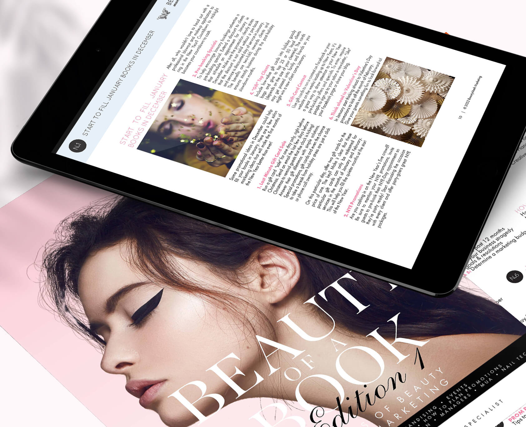 a tablet and a magazine displaying hair salon ideas