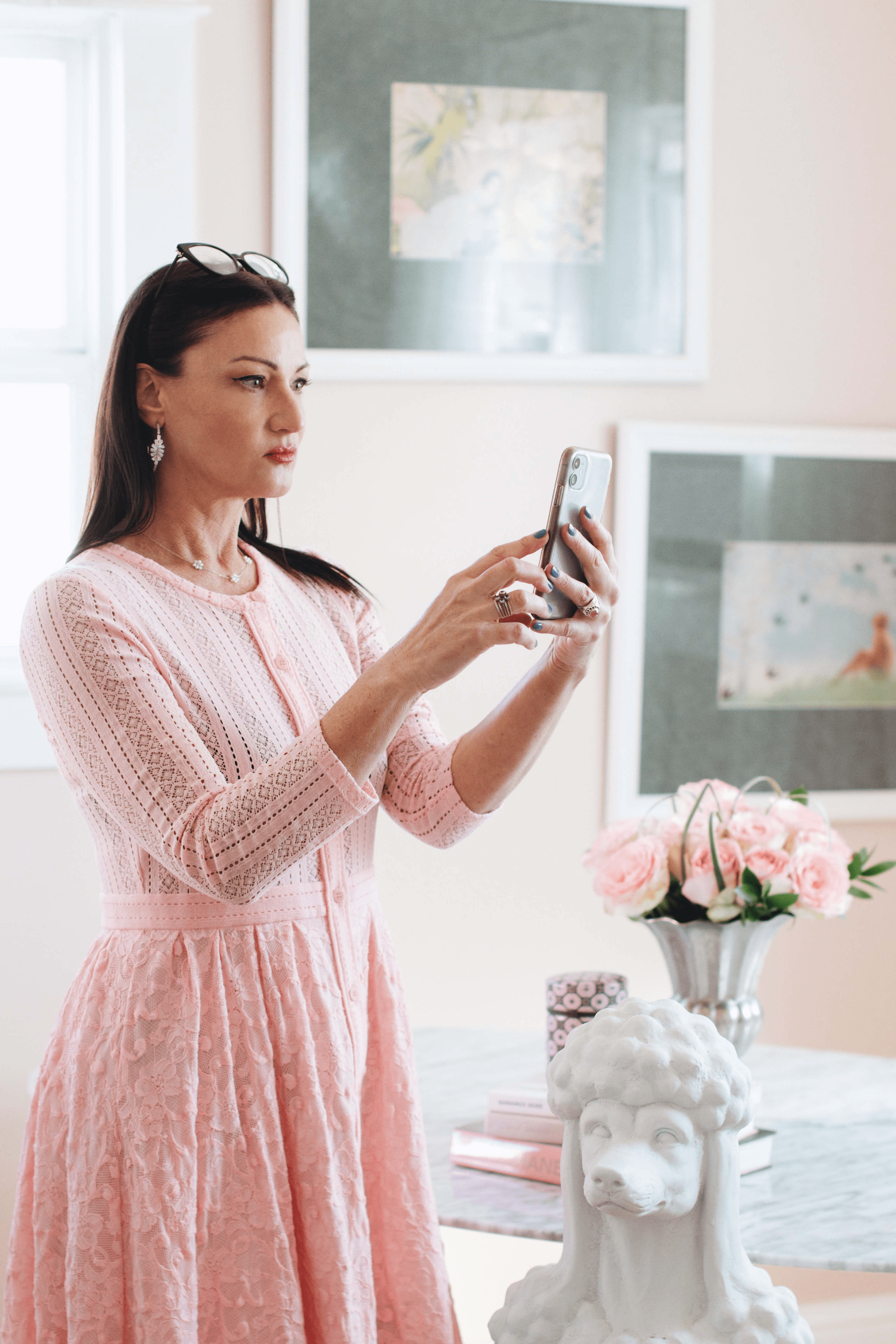 beauty marketing expert Kierna Terrisse posed standing looking at her phone